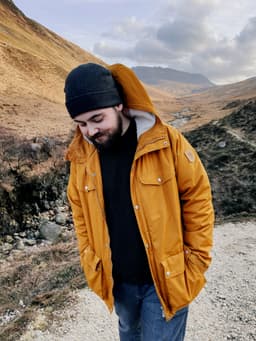 photo of Alex, the founder of FELD, on a mountain in scotland